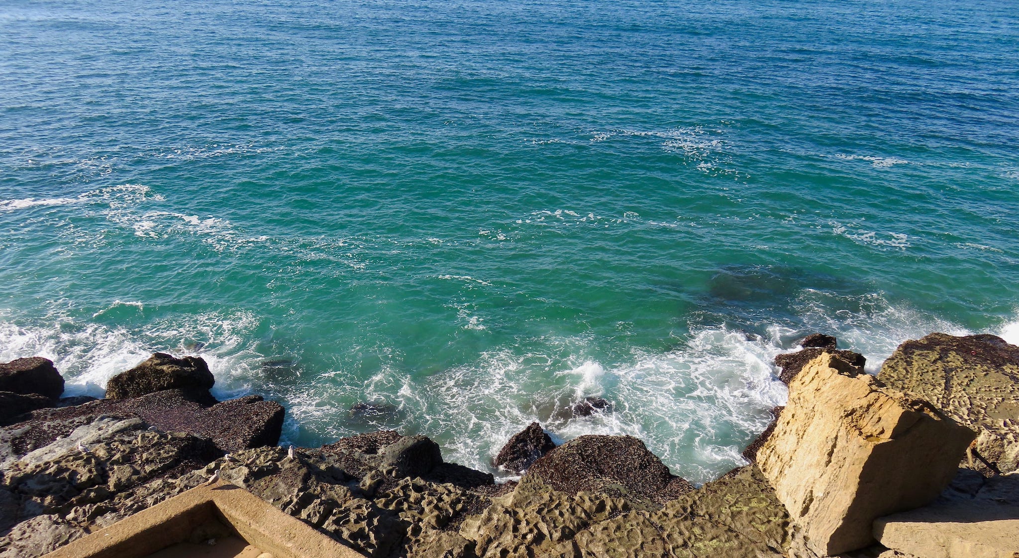 a view towards the sea from a rocky location